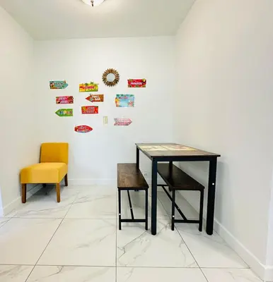 a dining room with a table and a chair at Spacious Studio heart Of Miami in Miami