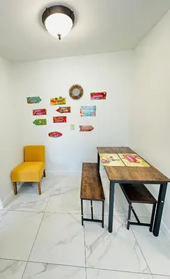 a room with a table and a yellow chair at Spacious Studio heart Of Miami in Miami