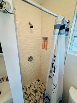 a shower with a shower curtain in a bathroom at Spacious Studio heart Of Miami in Miami