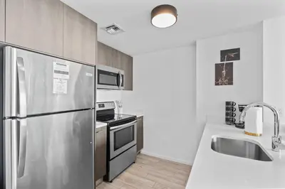 a kitchen with a stainless steel refrigerator and a sink at Miami Luxury Suite Infinity Pool in Miami