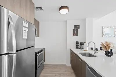 a kitchen with a stainless steel refrigerator and a sink at Miami Luxury Suite Infinity Pool in Miami