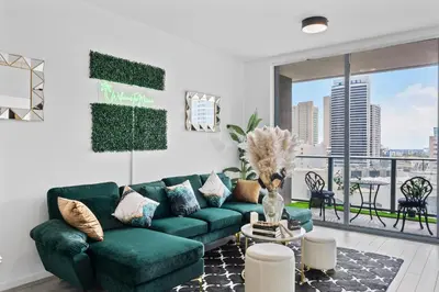 a living room with a green couch and a large window at Miami Luxury Suite Infinity Pool in Miami