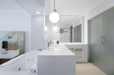 a white bathroom with a sink and a mirror at WVR Vacation Residences 2306 in Fort Lauderdale