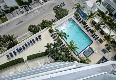 an overhead view of a large swimming pool with palm trees at WVR Vacation Residences 2306 in Fort Lauderdale