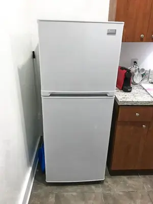 a white refrigerator freezer sitting in a kitchen at Miami Designer Apartment Unit 3 in Miami