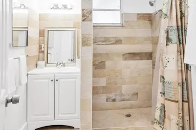 a bathroom with a white sink and a shower at Miami Designer Apartment Unit 3 in Miami