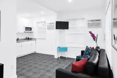 a living room with a couch and a kitchen at Miami Designer Apartment Unit 4 in Miami