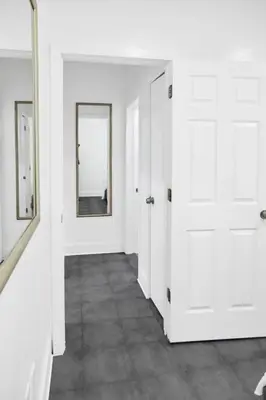 a hallway with two white doors and a mirror at Miami Designer Apartment Unit 4 in Miami