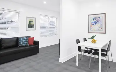 a living room with a black couch and a white table at Miami Designer Apartment Unit 4 in Miami