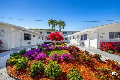 a garden in the middle of a building with flowers at Cozy 1-BD Miami Apt Gym, BBQ, Free Parking in Miami