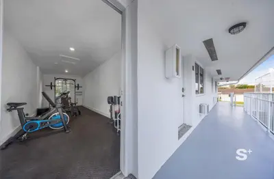 an open hallway with a gym with a treadmill at Cozy 1-BD Miami Apt Gym, BBQ, Free Parking in Miami
