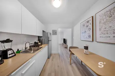 a kitchen with white cabinets and a wooden table at Chic 1-BD Apt in Miami Gym, BBQ, Free Parking in Miami