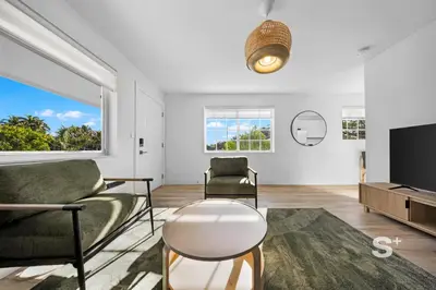 a living room with a couch and a tv at Miami Retreat - 1-BR Parking, Gym & BBQ Area in Miami