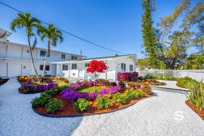 a garden with flowers in front of a building at Modern 1-BD Miami Apt Gym, BBQ, Free Parking in Miami