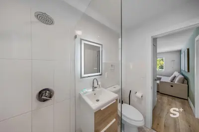 a white bathroom with a toilet and a sink at Modern 1-BD Miami Apt Gym, BBQ, Free Parking in Miami