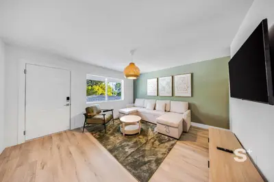 a living room with a couch and a tv at Modern 1-BD Miami Apt Gym, BBQ, Free Parking in Miami