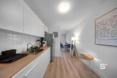 a kitchen with white cabinets and a counter top at Modern 1-BD Miami Apt Gym, BBQ, Free Parking in Miami