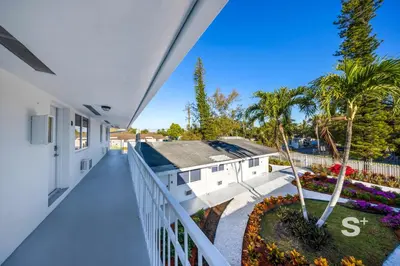 an empty balcony of a house with palm trees at Modern 1-BD Miami Apt Gym, BBQ, Free Parking in Miami