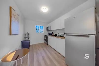a kitchen with white walls and a wooden floor at Modern 1-BD Miami Apt Gym, BBQ, Free Parking in Miami