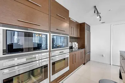 a kitchen with wooden cabinets and stainless steel appliances at Moderne 2 bed 2 bath Residence in Miami