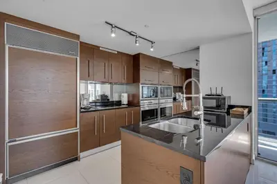 a kitchen with wooden cabinets and a counter top at Moderne 2 bed 2 bath Residence in Miami