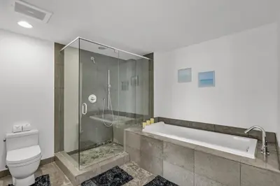 a bathroom with a tub and a toilet and a shower at icon Brickell 2 bed 2bath at W residence in Miami