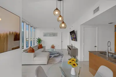 a living room with a white couch and a sink at icon Brickell 2 bed 2bath at W residence in Miami