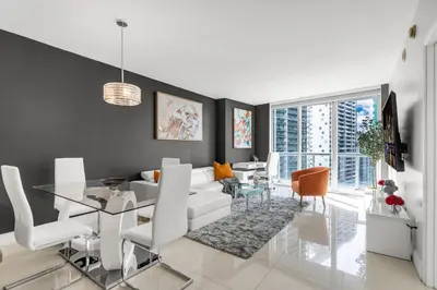 a living room with a white couch and a glass table at Icon brickell 1 bed 1 bath residence in Miami