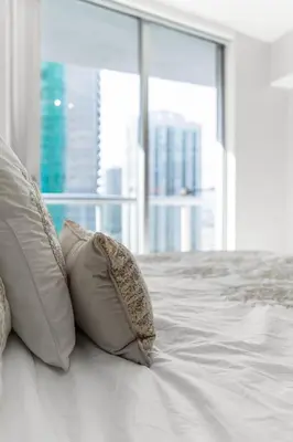 two pillows on a bed in a room with a window at Icon brickell 1 bed 1 bath residence in Miami