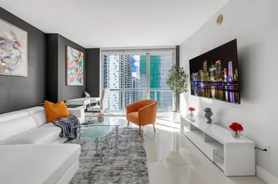 a living room with a white couch and a glass table at Icon brickell 1 bed 1 bath residence in Miami