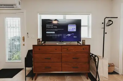 a television on top of a dresser in a living room at Cozy Miami Suite with FREE Parking in Miami