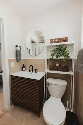 a bathroom with a toilet and a mirror at Cozy Miami Suite with FREE Parking in Miami