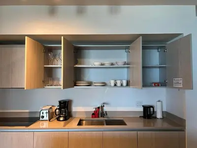 a kitchen with wooden cabinets and a sink in it at LYFE, Rent Excelent Apartment in Resort, 4Pax ,Parcial Ocean View in Hollywood