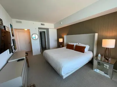 a hotel room with a bed and a television at LYFE, Rent Excelent Apartment in Resort, 4Pax ,Parcial Ocean View in Hollywood