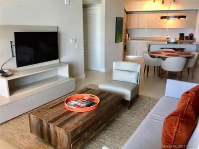 a living room with a couch and a tv and a table at LYFE, Rent Excelent Apartment in Resort, 4Pax ,Parcial Ocean View in Hollywood