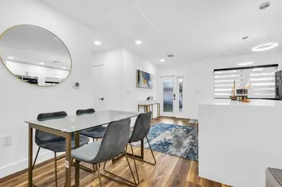 a dining room with a table and chairs and a mirror at Modern Home with large private yard - Next to downtown & beach & airport - Pet friendly in Fort Lauderdale