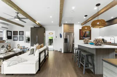 a living room with white furniture and a kitchen at Stunning, Modern and Quiet Beach House in Hollywood