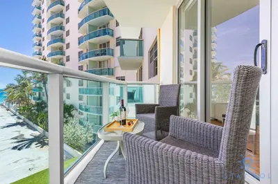 a balcony with chairs and a table on a balcony at Tides beautiful ocean view condo-promotions in Hollywood