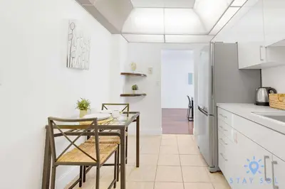 a kitchen with a table and chairs and a refrigerator at Tides Great condo on the beach Big promotions in Hollywood