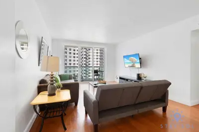 a living room with a couch and a table at Tides Great condo on the beach Big promotions in Hollywood
