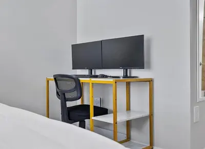 a bedroom with a desk with a tv and a chair at Miami Oasis With Private Pool in Richmond West