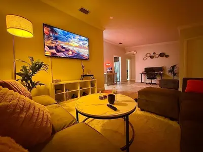 a living room with a couch and a tv on the wall at Miami Oasis With Private Pool in Richmond West