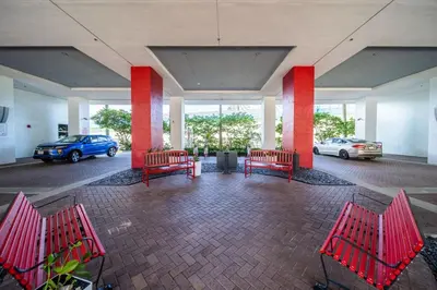 a group of red benches in a parking lot at Hallandale Beach Apmt 1B1B with Beach Service & Pool Service in Hallandale Beach