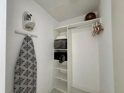a closet with a tie hanging on a wall at Hallandale Beach Apmt 1B1B with Beach Service & Pool Service in Hallandale Beach