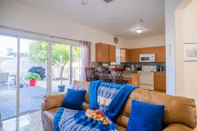 a living room with a brown leather couch with blue pillows at Luxury DreamStay Miami 3BED 2BATH King Suite in Burrs Strip