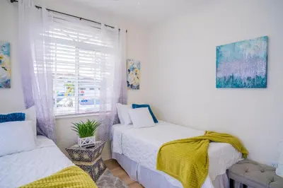 a bedroom with two beds and a window at Luxury DreamStay Miami 3BED 2BATH King Suite in Burrs Strip