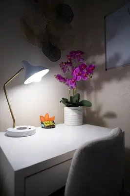 a desk with a lamp and a vase of purple flowers at Hidden Gem Luxe 1 BEDROOM & Patio in Cutler Bay