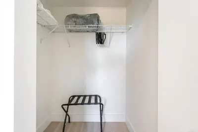 a black chair in a room with a wall at New 2br 2bath 5 mins from beach 15 mins airport in Hallandale Beach