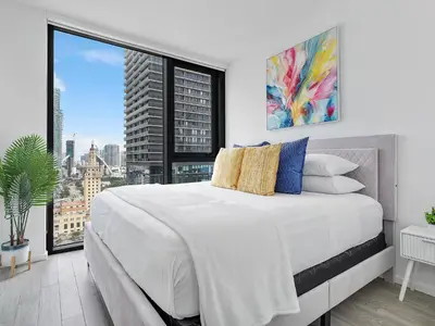 a bedroom with a large bed and a large window at X Lounge V-Panoramic Private Residence in Miami