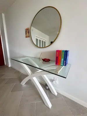 a glass table with books on it with a mirror at Beachfront one bedroom in the Tides in Hollywood in Hollywood